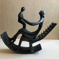 In the style of Henry Moore, Mother and Child in Rocking Chair